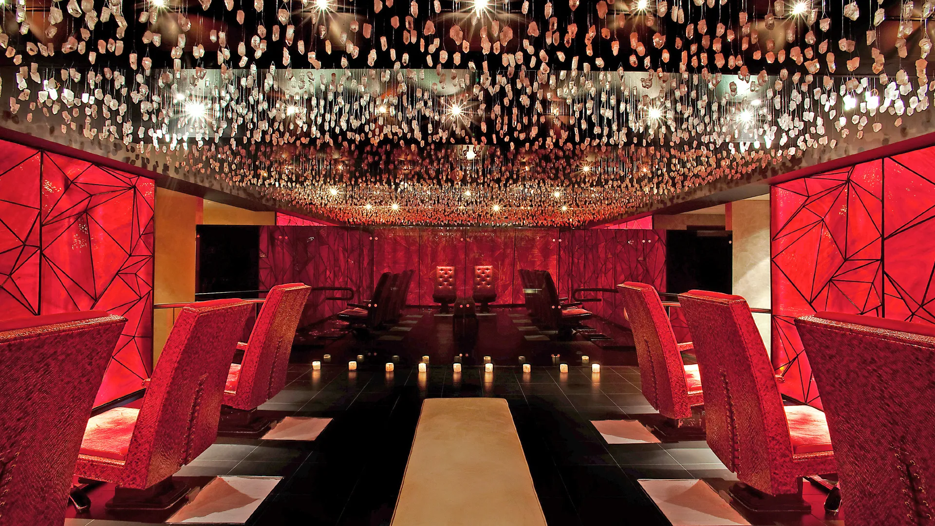Crystal room at Reflections Spa featuring red chairs.