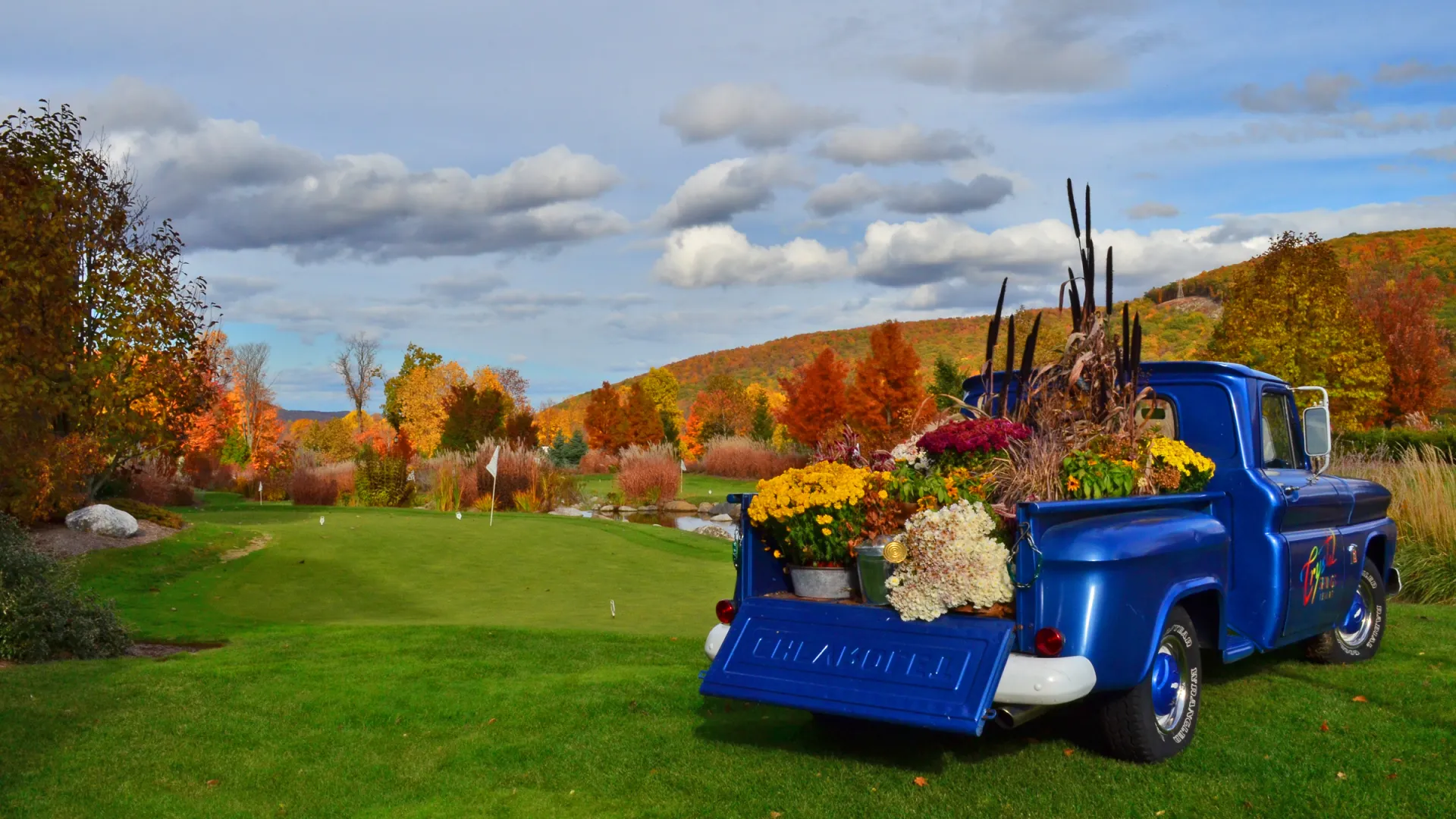 The Crystal Springs Blue truck on the natural grass putting course at Grand Cascades Lodge