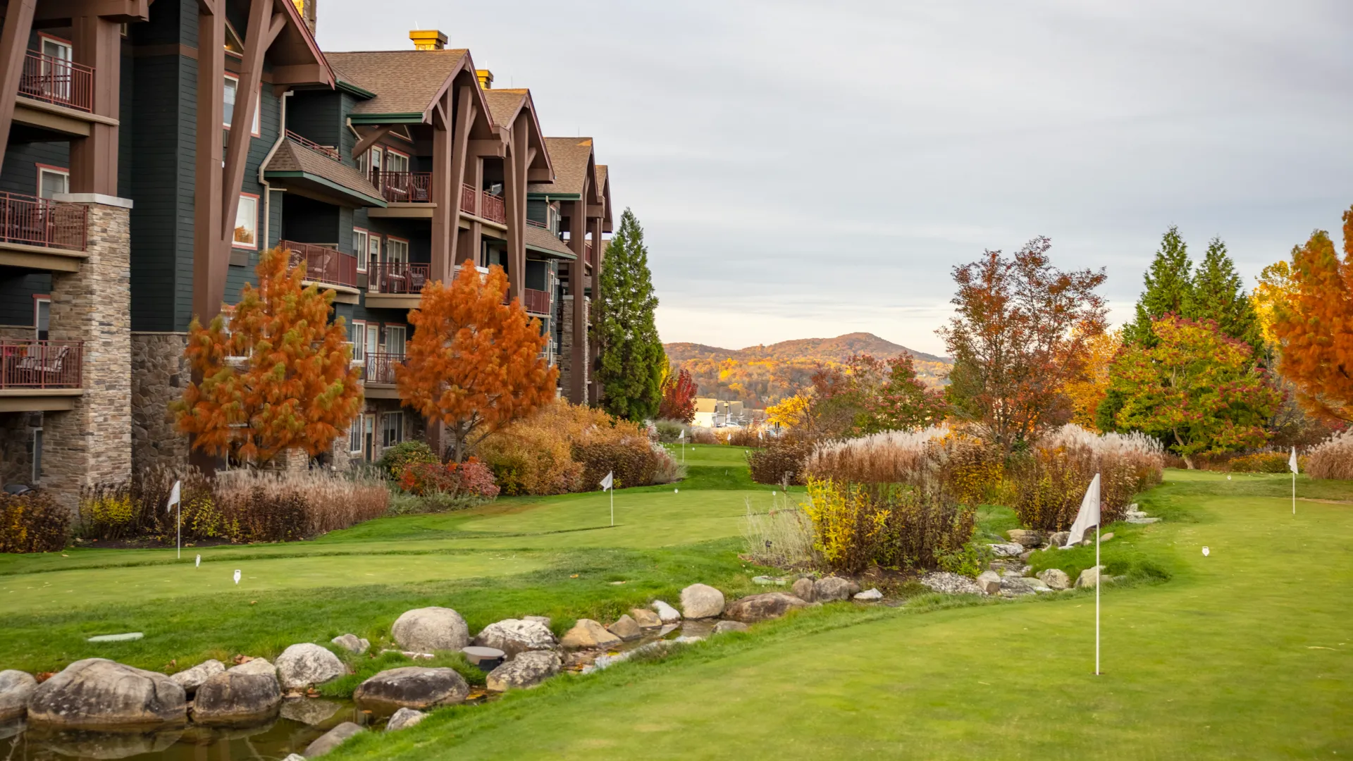 Grand Cascades Lodge in Fall with mountains in back.