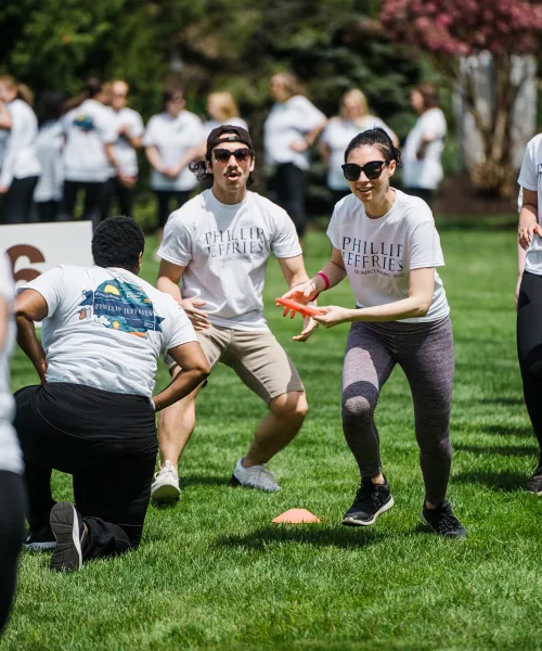 Group playing frisbee during teambuilding exercise.