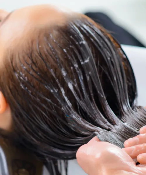 Deep conditioning treatment on clients hair.