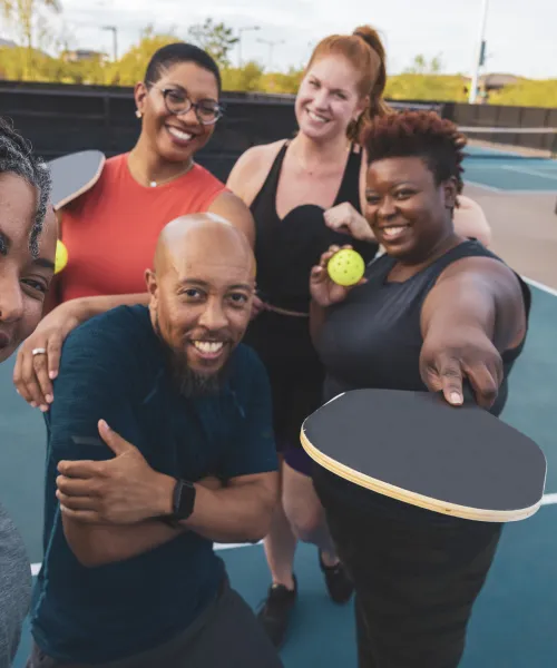 Group of friends playing pickleball.