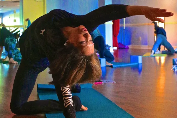 Woman reaching arm backwards during yoga.