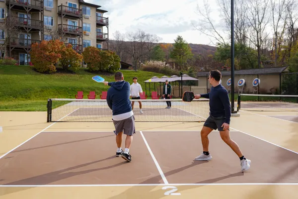 Four men playing pickleball.