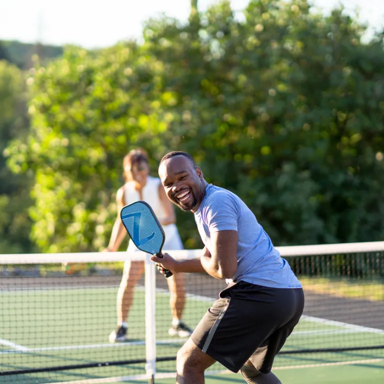 Four people playing pickleball