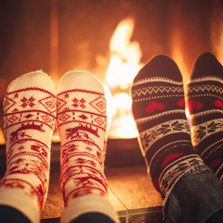 Winter socks in front of cozy fire.