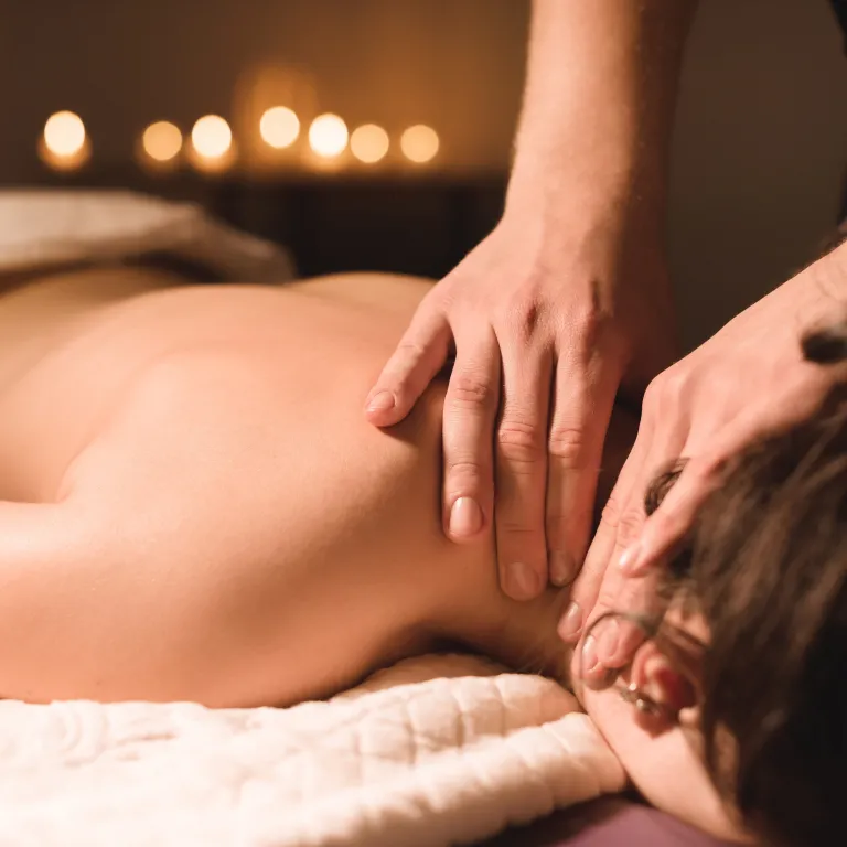 Woman receiving a massage on her neck.