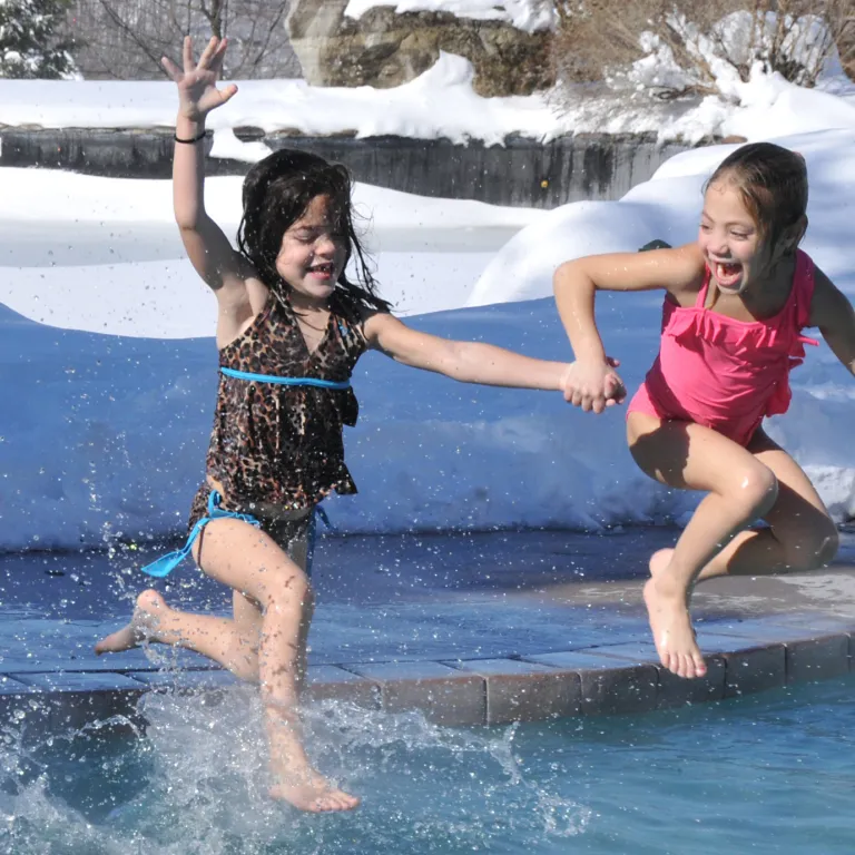 Young girls jumping into the snow pool at Minerals Hotel