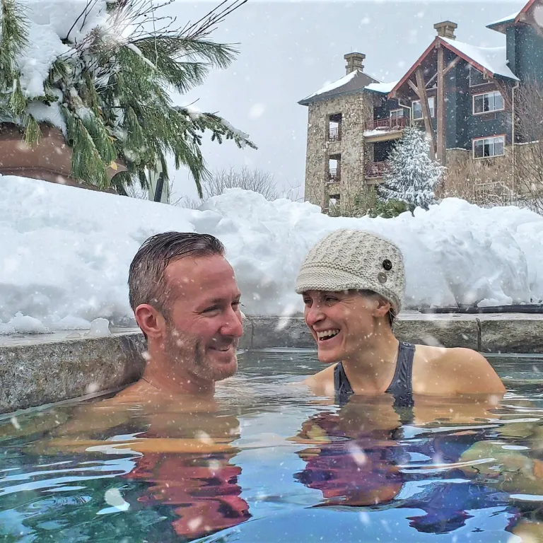 Couple enjoying the snow pool at Grand Cascades Lodge