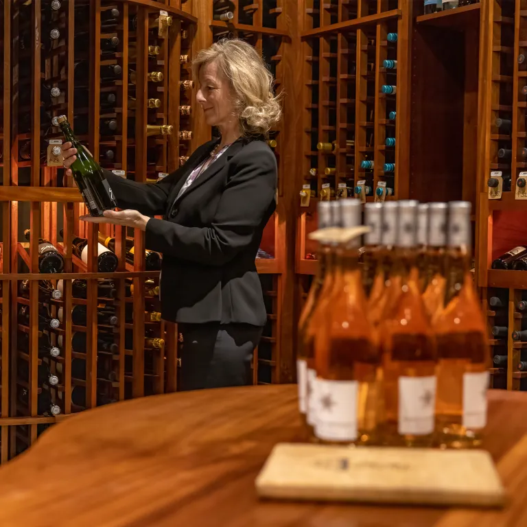 Sommelier selecting wine at The Curator 