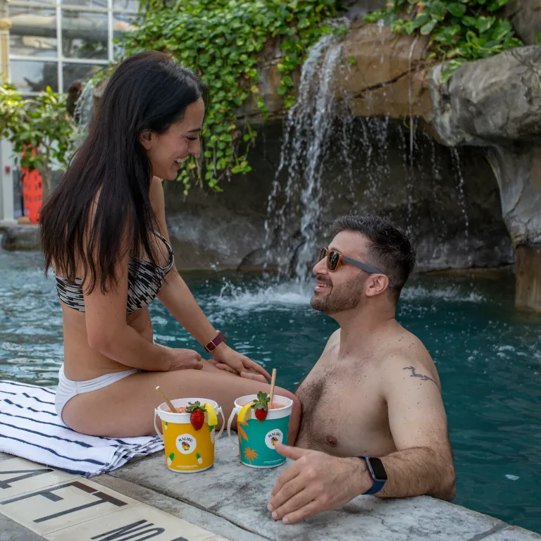 Couple drinking rum buckets at the Biosphere Indoor Pool