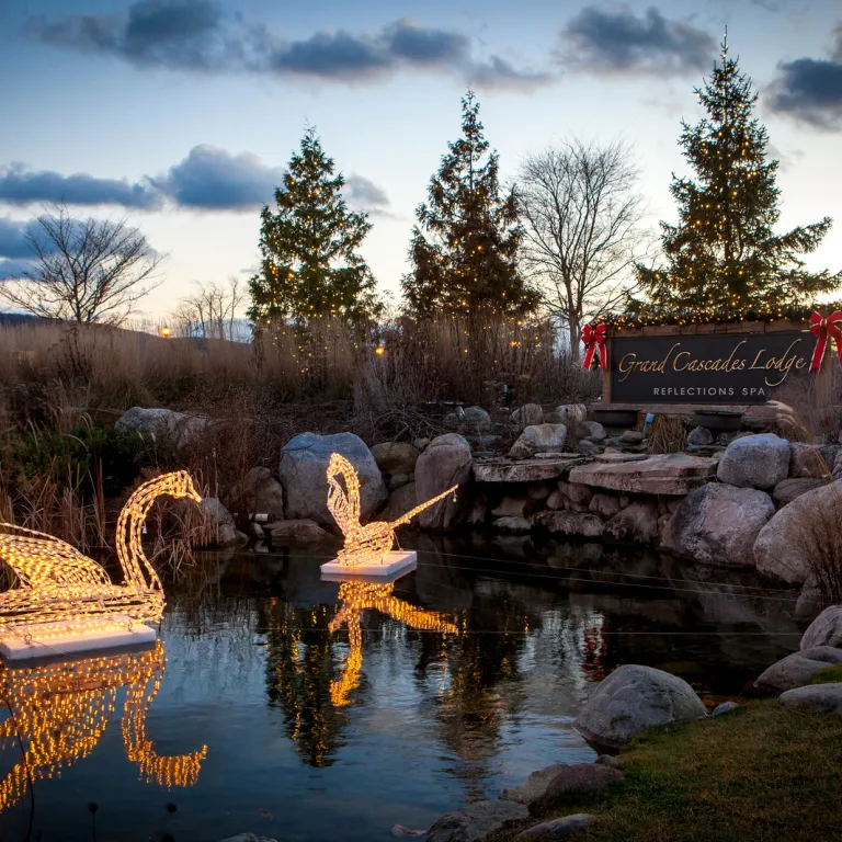 The pond in front of Grand Cascades in winter with holiday lights.