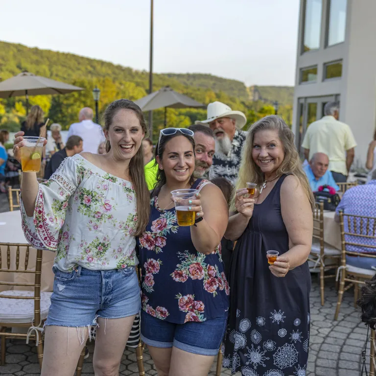 Women  holding beers at Black Bear bourbon and bbq.
