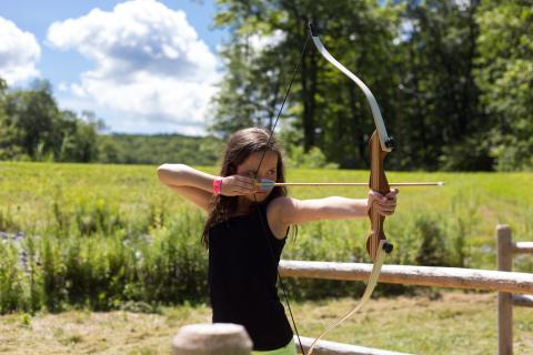 Girl shooting an arrow. 