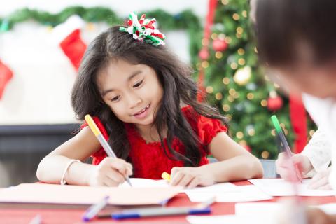 Little girl writing a letter to Santa