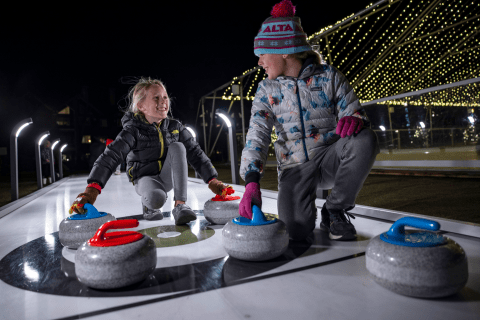 Two kids curling.