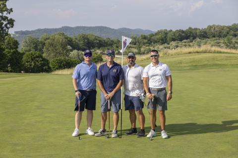 Four golfers stand together on Ballyowen Golf Course. 
