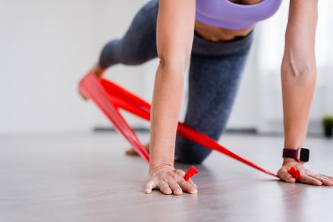 Woman using resistance bands during workout.