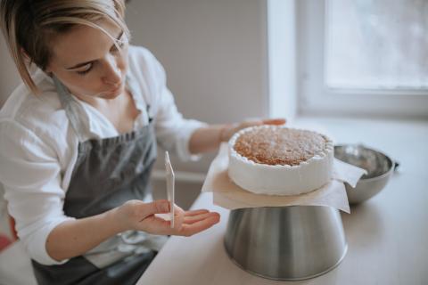 Baker preparing cake. 