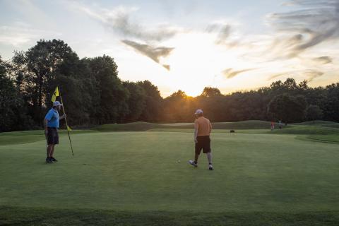 Two men on the putting green of Black Bear Golf Course