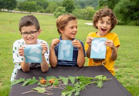 Kids holding their solar art prints.