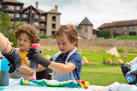 Children tie dyeing tee shirts.