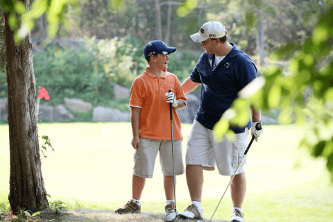 Father and son on a golf course at Crystal Springs Resort