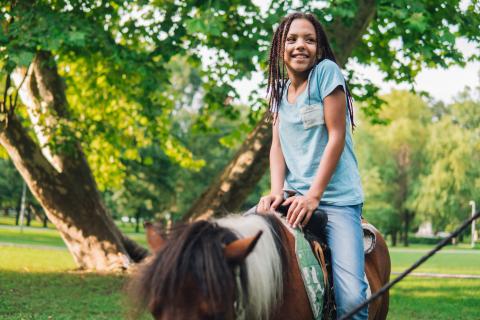 Young Girl Horseback Riding