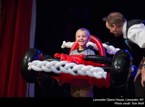 Balloon artist, John Cassidy, on stage with car made out of balloons.
