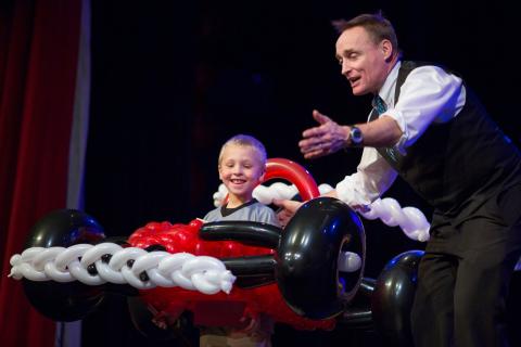 Balloon artist, John Cassidy, on stage with car made out of balloons.