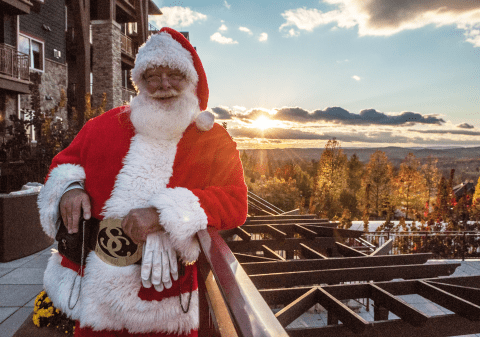 Santa in front of scenic view at Grand Cascades Lodge at Crystal Springs Resort NJ
