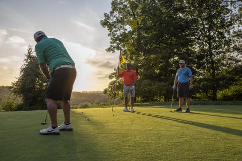 Three men on putting green