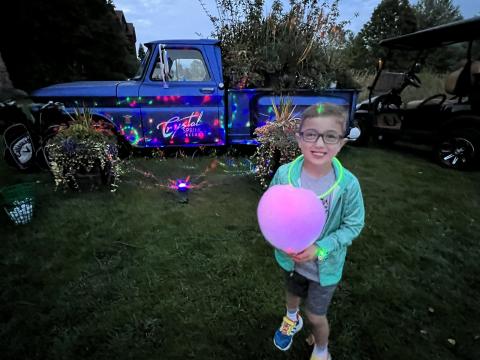 Child with glow cotton candy at Crystal Springs Resort.
