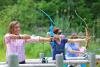 Group of people doing archery practice.