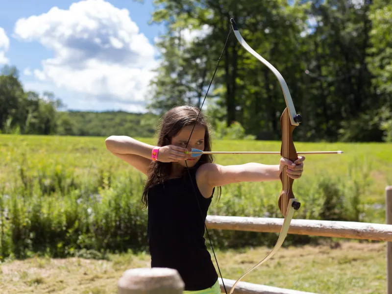 Girl shooting an arrow. 