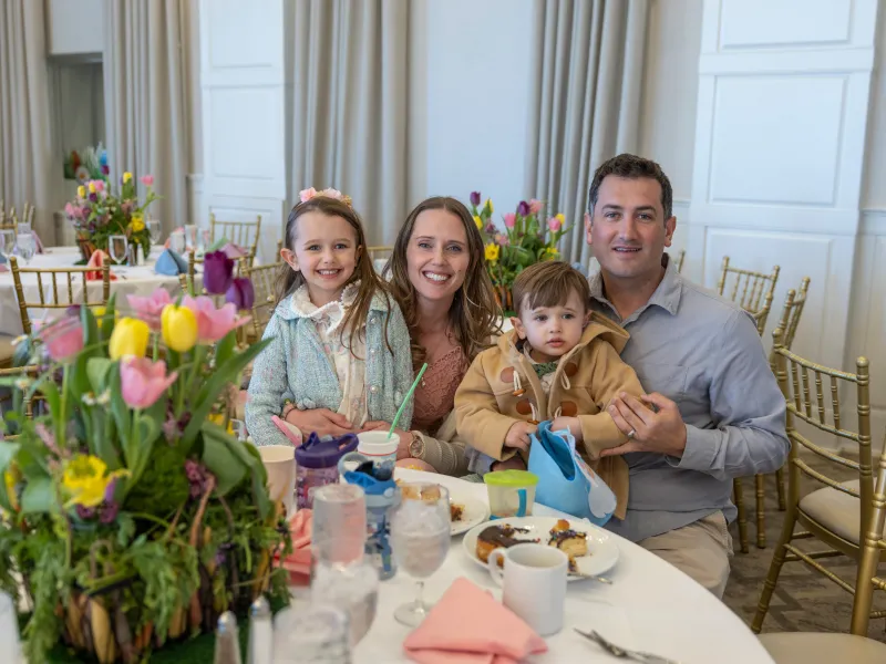 Family of four sitting at table in Emerald Ballroom for Mother's Day.