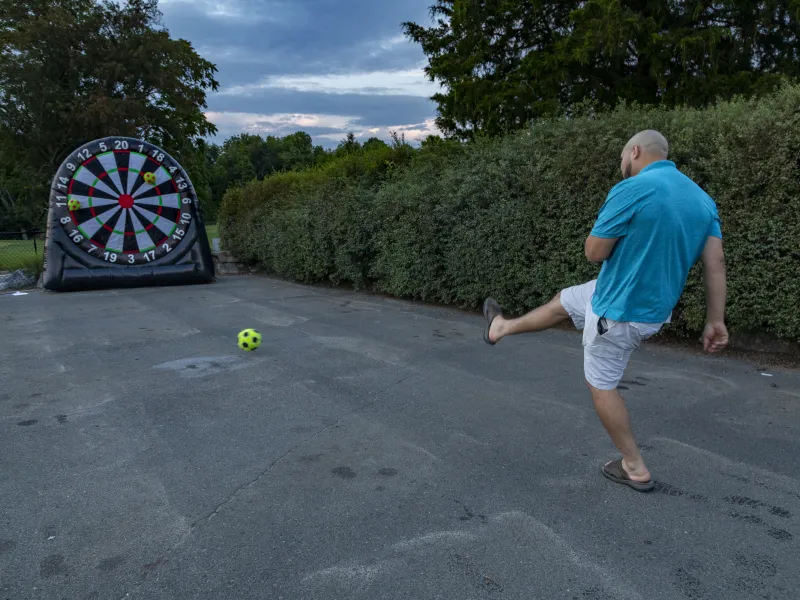 Man playing foot darts. 