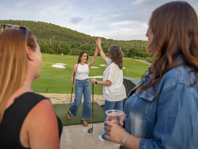 Woman high five at Black Bear Trackman Range