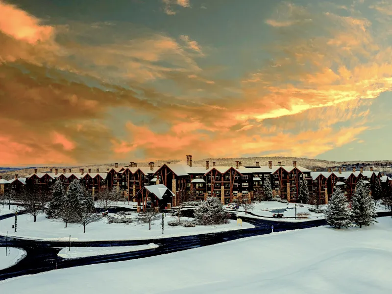 Grand Cascades Lodge exterior during winter with snow.
