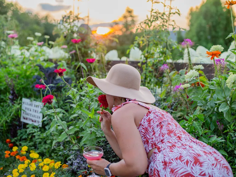 Woman smelling a flower in the Chef's Garden