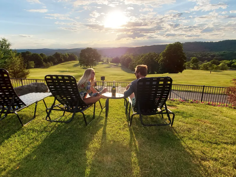 Couple sitting in Vista 180 pool chairs.
