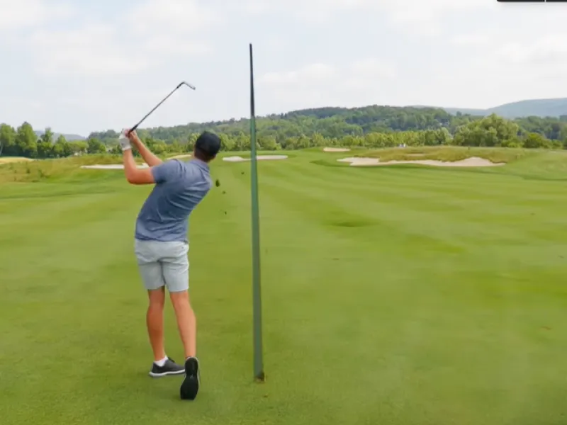 Garrett Clark swinging golf club.