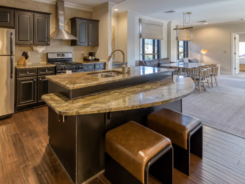 Eagle River suite at Grand Cascades Lodge featuring kitchen, dining room and living room.