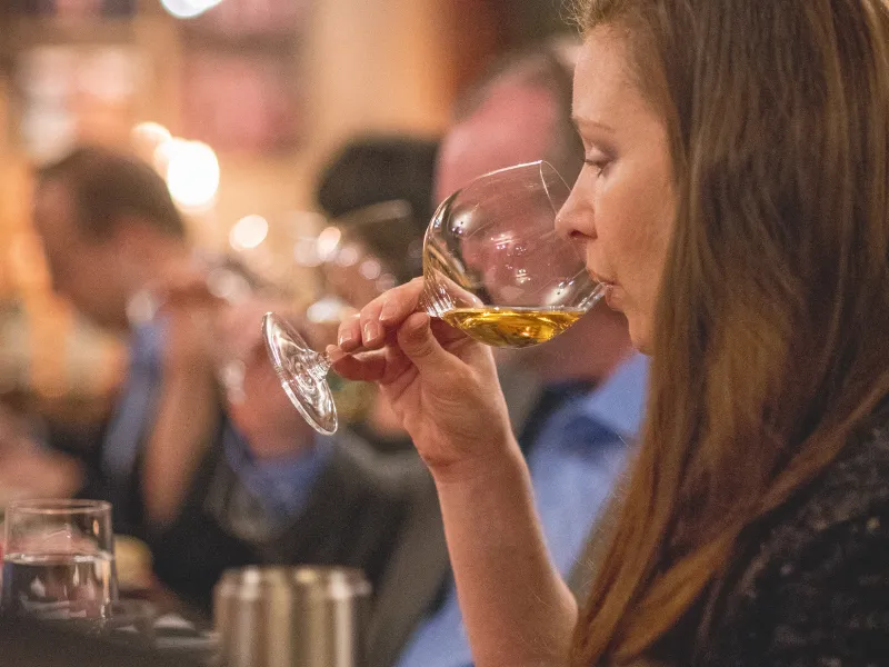 Woman drinking white wine.