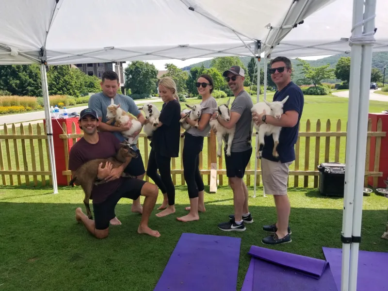 Family holding goats during goat yoga.