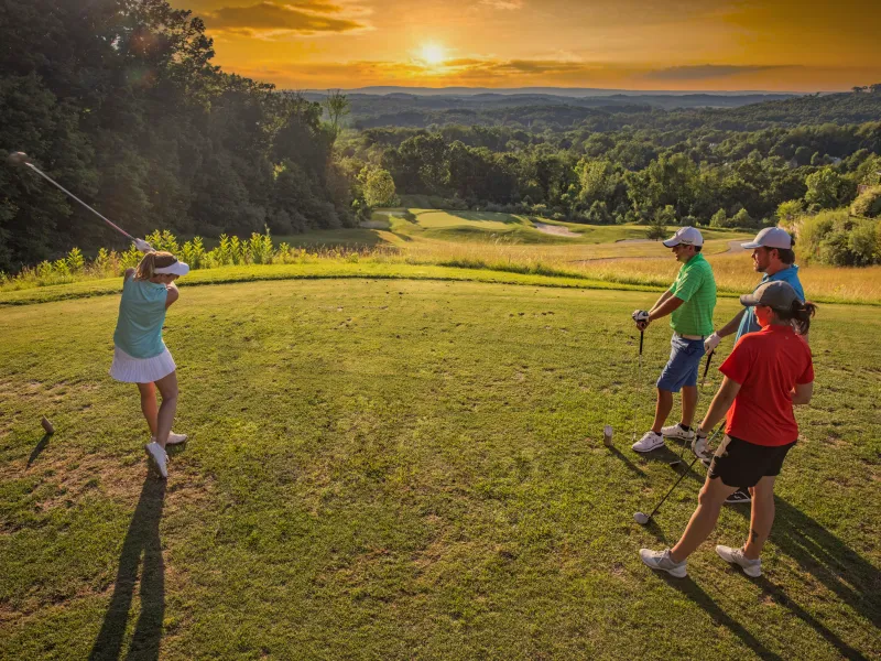 Golfers at sunset on the course of Wild Turkey at Crystal Springs Resort