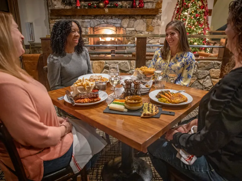 Girlfriends enjoying meal at Kites Restaurant during the Christmas season