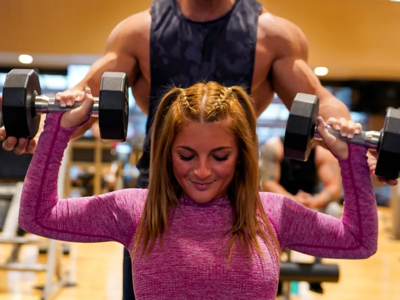 Woman working out with dumbbells.